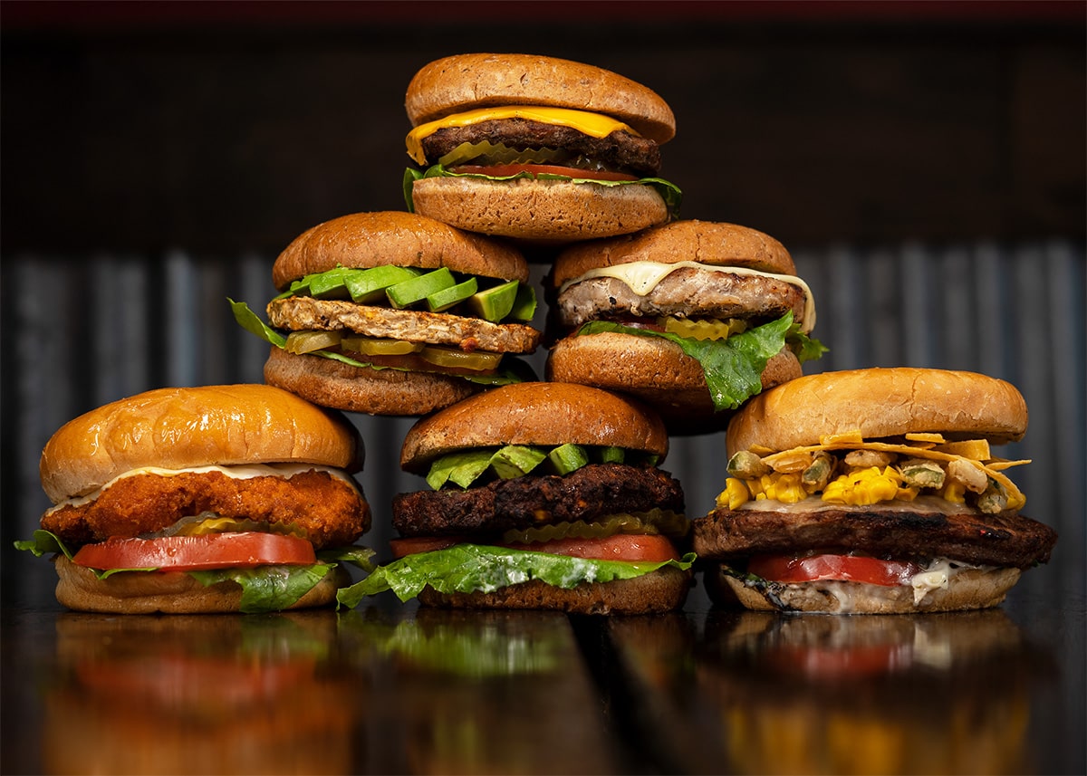 Assorted burgers stacked on a table