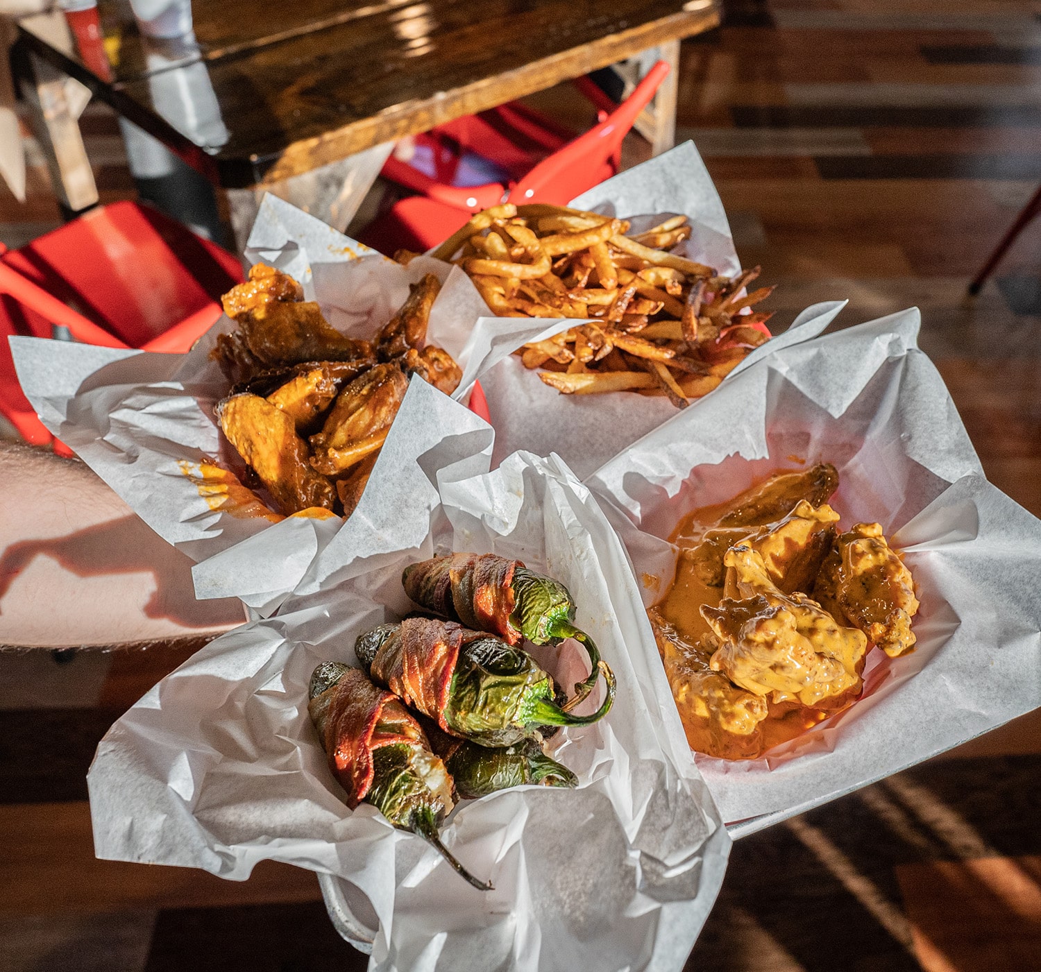 Baskets of wings, fries, and bacon-wrapped jalapeño poppers