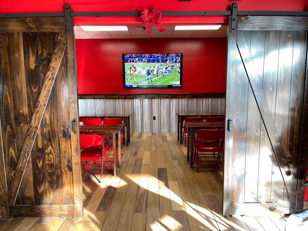 Wing Barn dining room with red walls and a longhorn skull on display