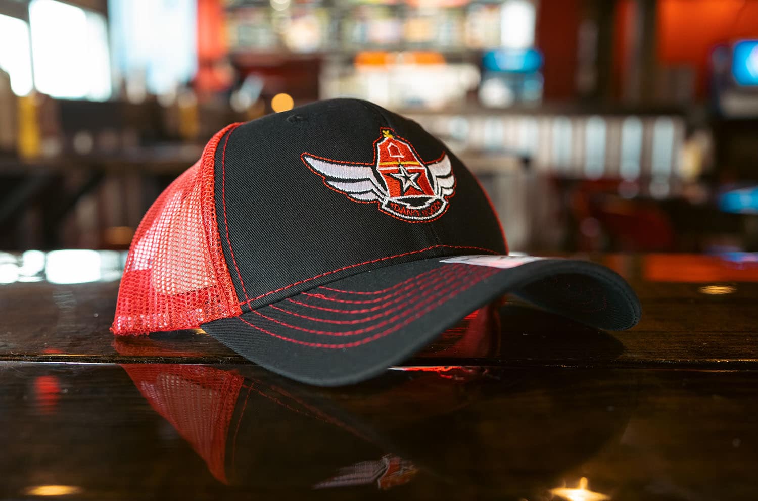 Black and red Wing Barn trucker cap with wings-and-star logo