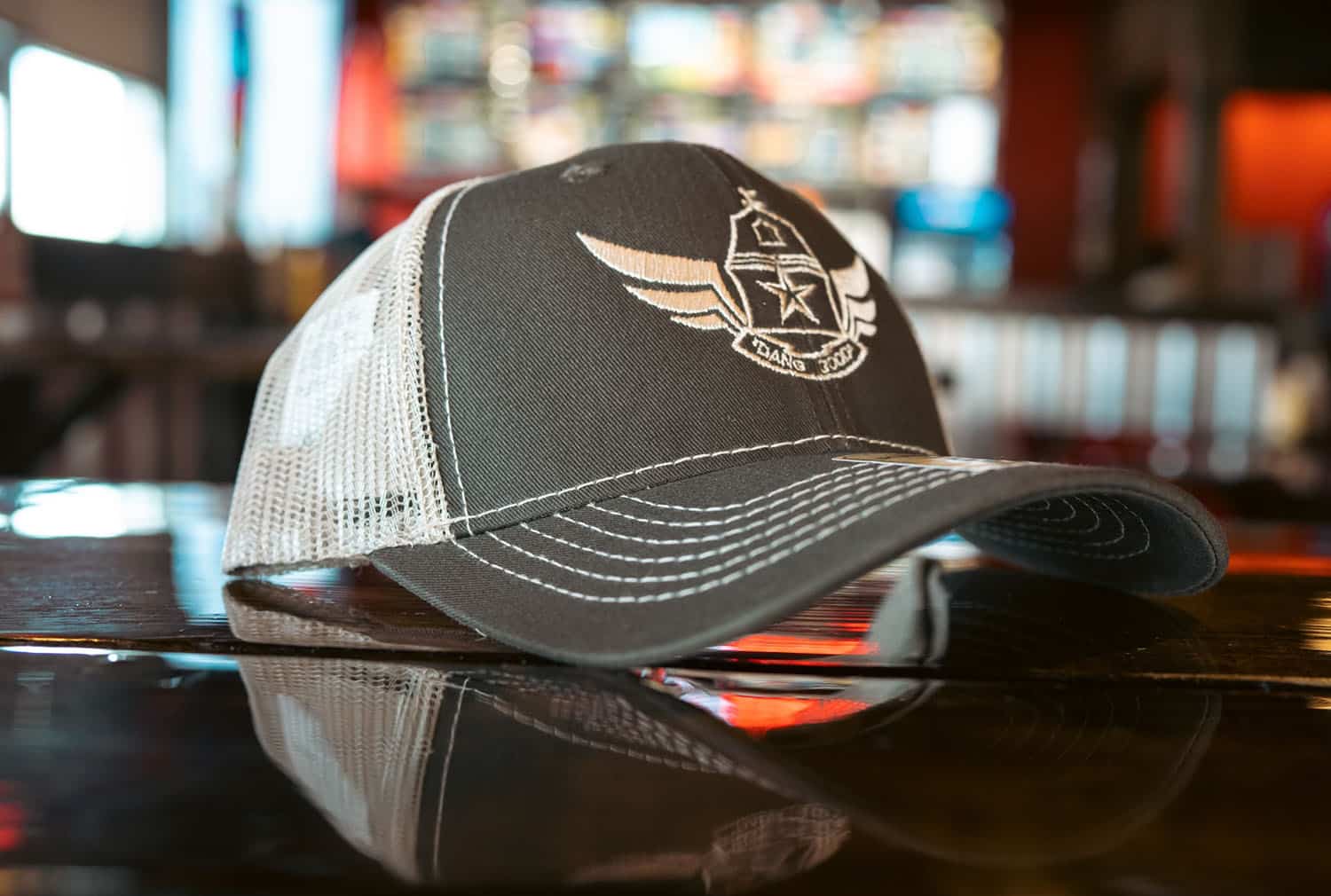 Gray and white Wing Barn trucker cap with wings-and-star logo